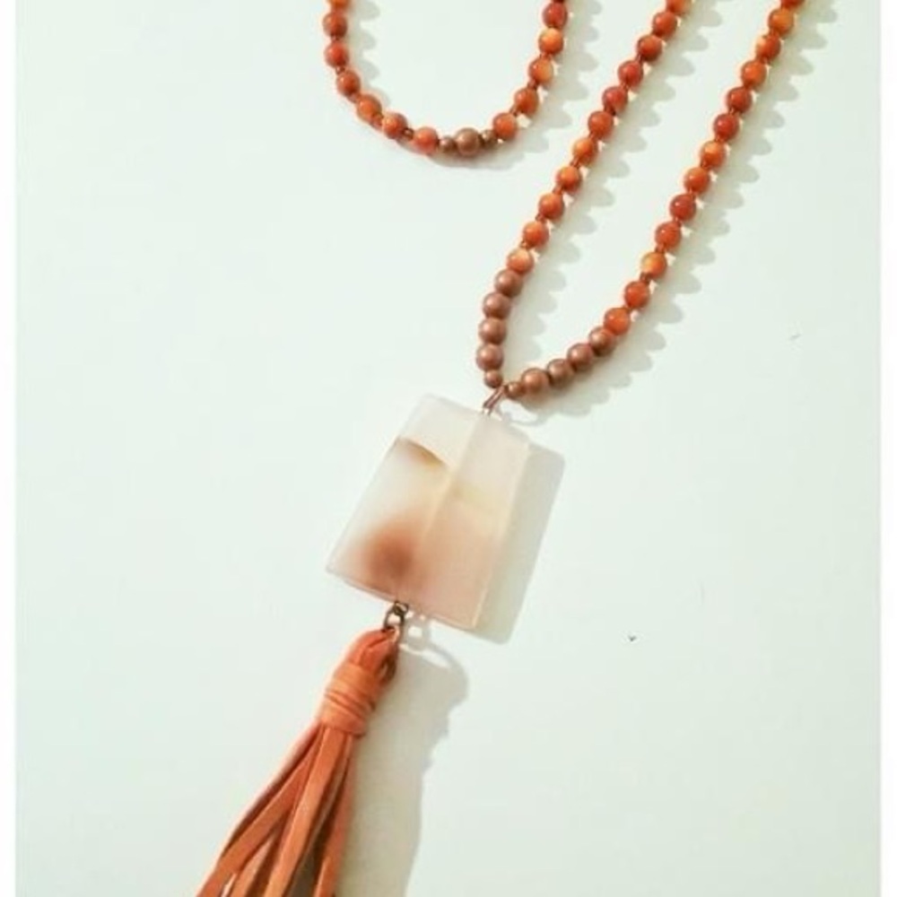 Necklace w/ leather tassel and an Agate ladder gemstone pendant.  Custom made.